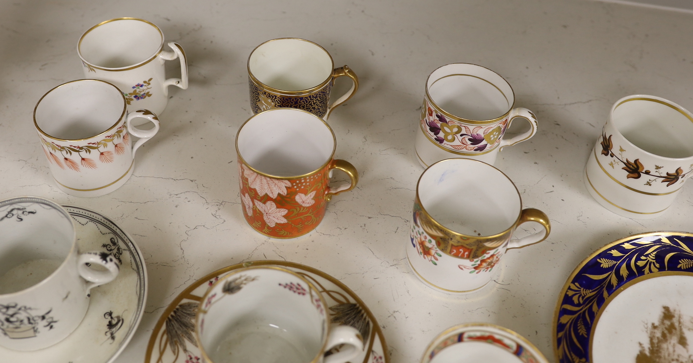 English porcelain coffee cans including Worcester, Spode, Wolfe Mason, Derby and Chamberlain, two New hall cans and saucers and a New hall Warburton’s Patent saucer dish, the largest 20cm in diameter